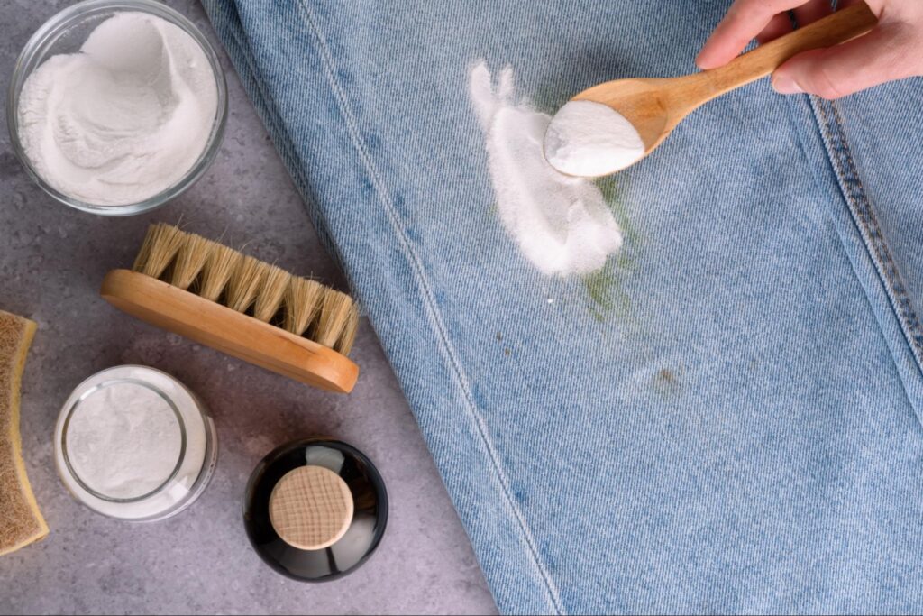Applying a baking soda and hydrogen peroxide paste to a grass-stained shirt