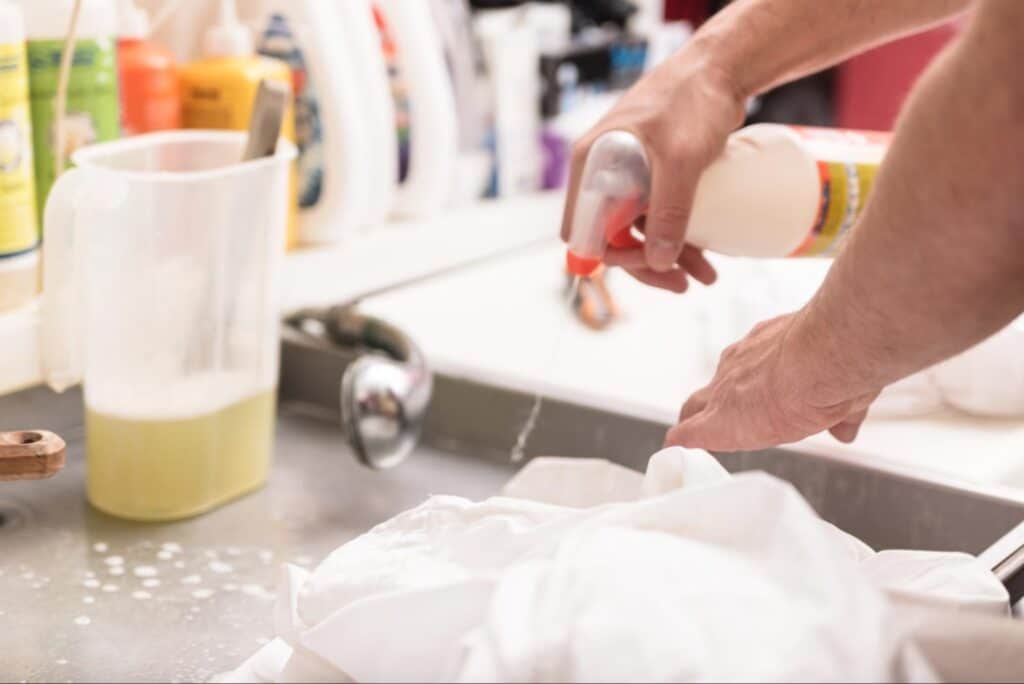 Laundry service washing clothes for stain removal