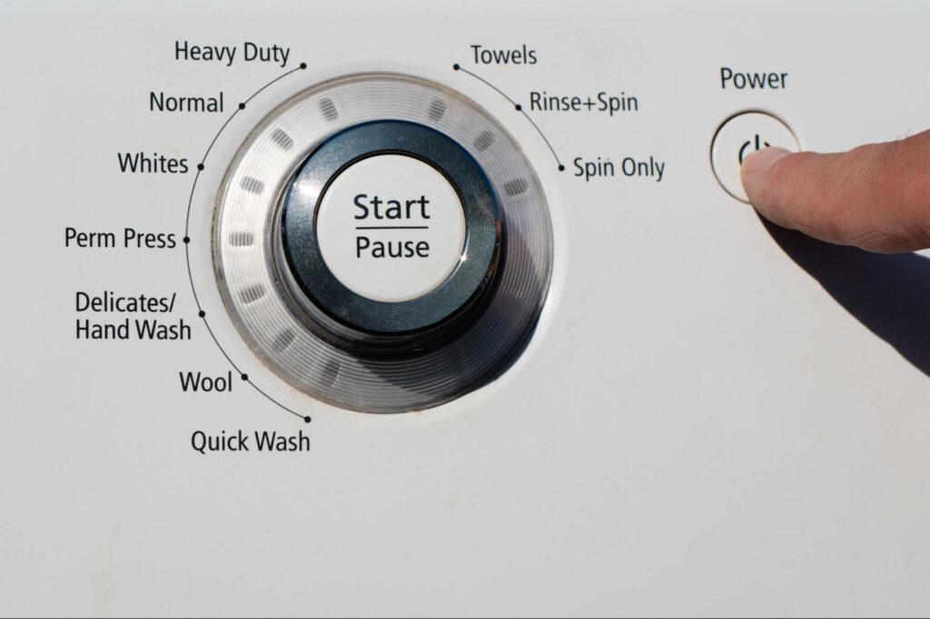 Washing machine control panel close-up with cycle options