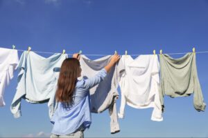 clothes hanging outside on a clothesline to air out and remove odors