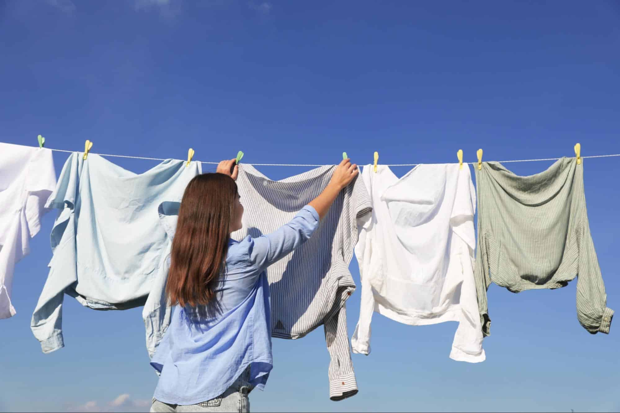 clothes hanging outside on a clothesline to air out and remove odors