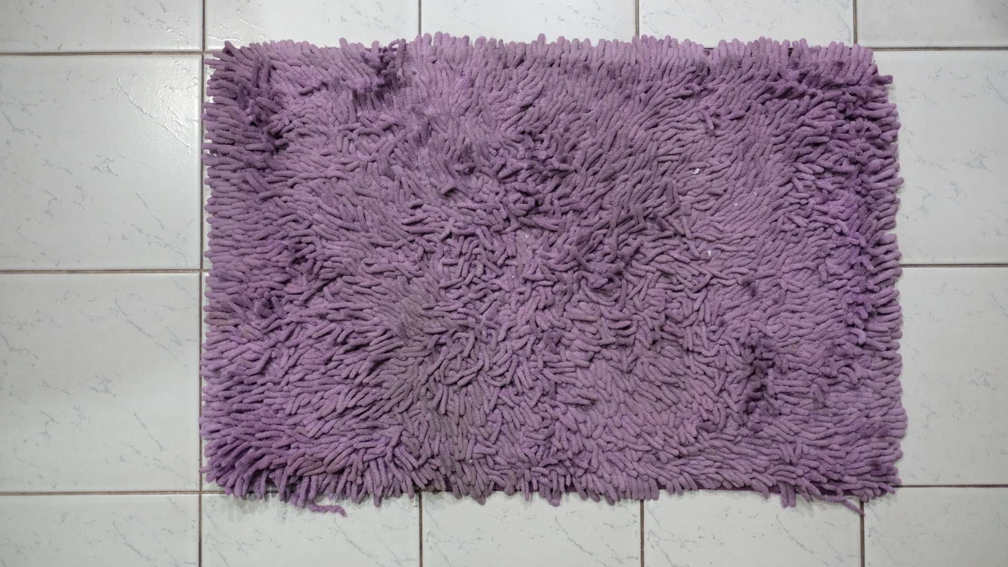 Small rubber-backed bath mats and rugs ready to be washed