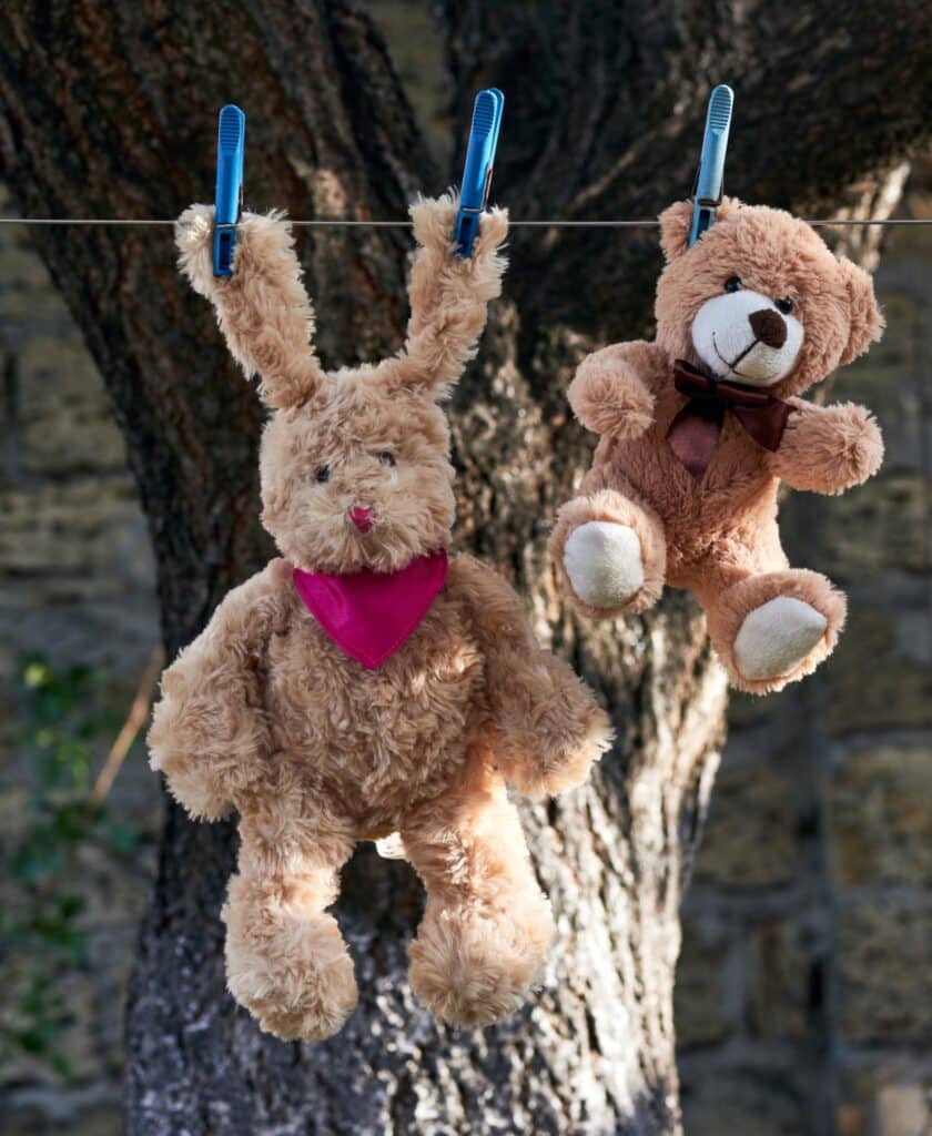 Clean plush toys air drying on a clothesline