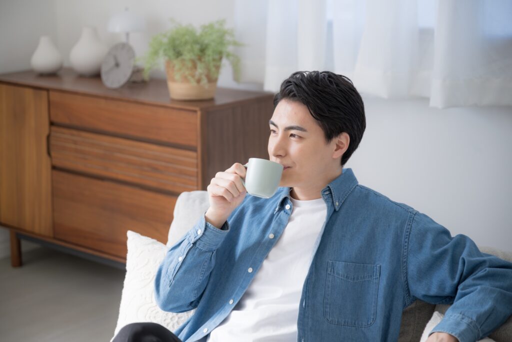  Person relaxing with a cup of coffee while folded laundry is delivered to their doorstep