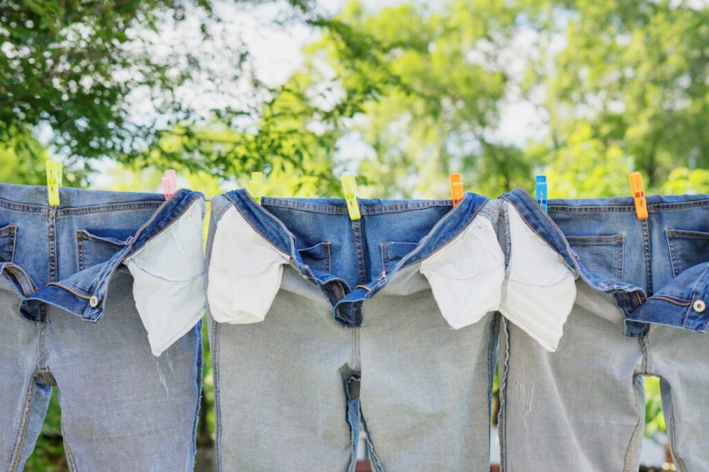 Dark jeans hanging on a clothesline, away from direct sunlight