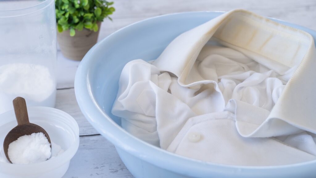White clothes soaking in a blue basin