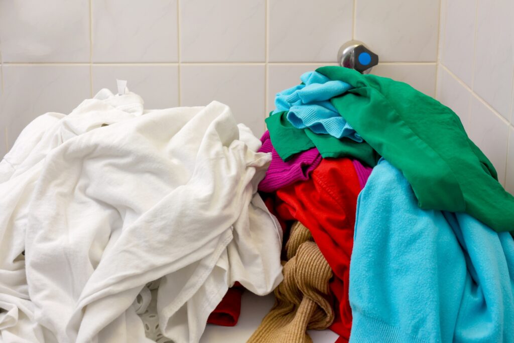 Pile of mixed clothes separated for laundry sorting