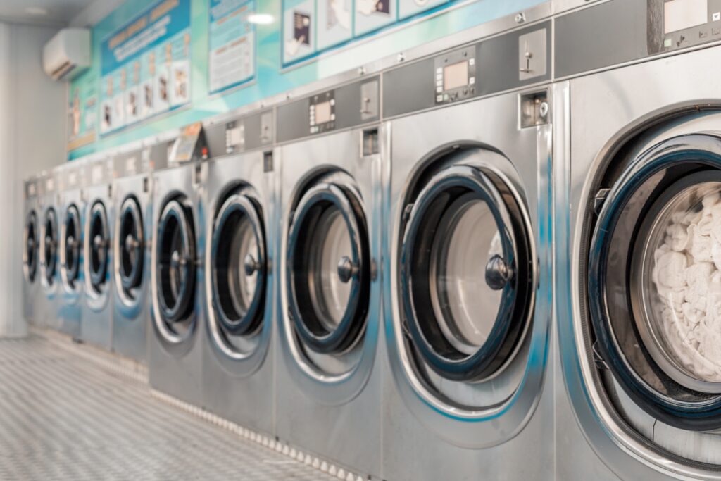 Row of commercial washing machines in a laundromat