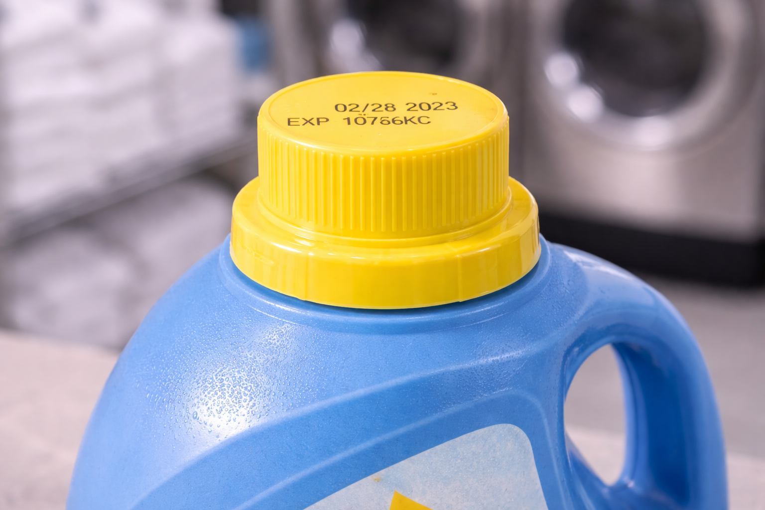 Blue detergent bottle with yellow cap